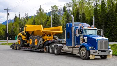 Heavy-duty dump truck on flatbed trailer