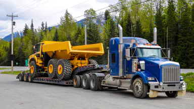 Heavy-duty dump truck on flatbed trailer