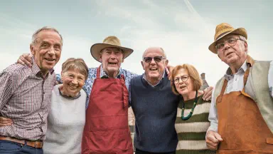 Senior friends smiling together outdoors.